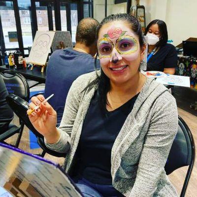 Painted and Painting at the Dia De Los Muertos celebration.