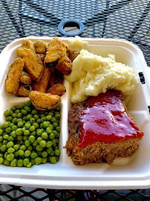 Meatloaf with mashed potatoes, fried zucchini, and peas