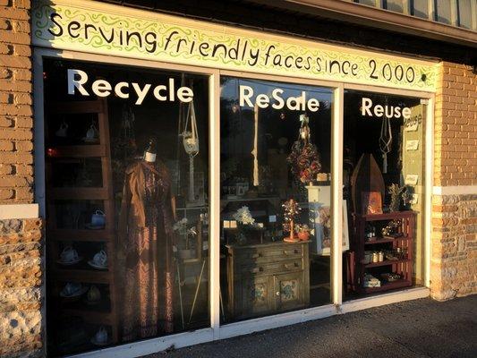 Display window decorated with items from local artist found at Mine & Yours Asheville Resale