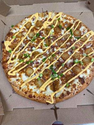 The LOADED TOT-ZZA - a tater tot and cheese pizza with smoked bacon and green onion. That's ranch dressing