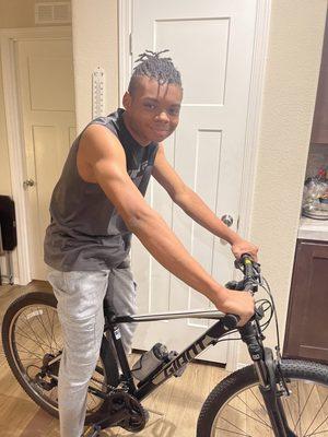 TJ sitting on his new Giant Mountain Bike. Looking good TJ.  Julie A