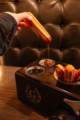 Churro dipped in cajeta (special Mexican caramel).