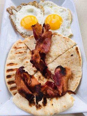 Two Sunny Side Eggs with bacon and pita