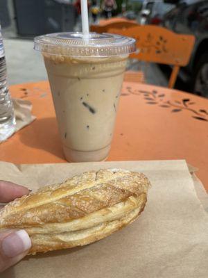 Iced latte and apple leaf pastry.