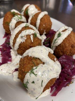 Sauerkraut, mashed potatoes, on a bed of haus made rotkohl, served with a creamy sour cream, dill and creole mustard sauce.