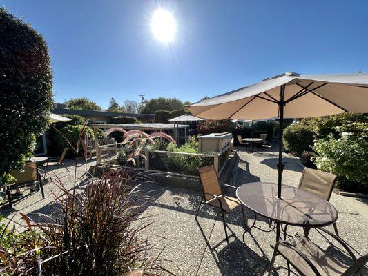 Lovely patio space where you can be immersed in perfectly kept gardens boasting exotic flowers and hedges.