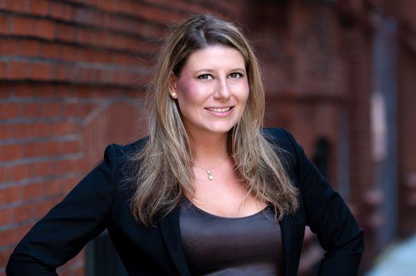 LinkedIn headshot on a Bokeh background