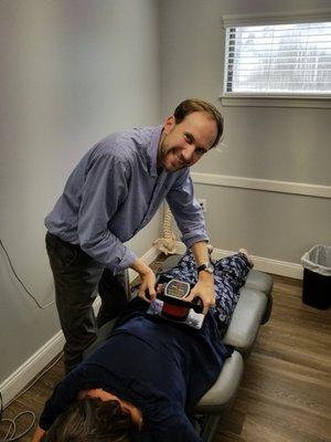 Dr. Nathan Luoma getting patients loose with his vibration machine.