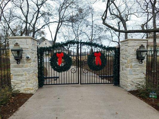 Auto gate dual swing and stone columns. Gate has custom H in center all design build by Green and Son. Prosper, Texas.