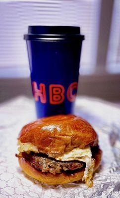 Sausage egg & cheese on a HBC brioche bun with a large hot coffee - takeout