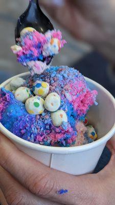 Two scoops of ice cream with cupcake bites and cotton Candy crunch as topping