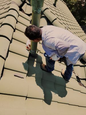 Maintenance on a tile roof.