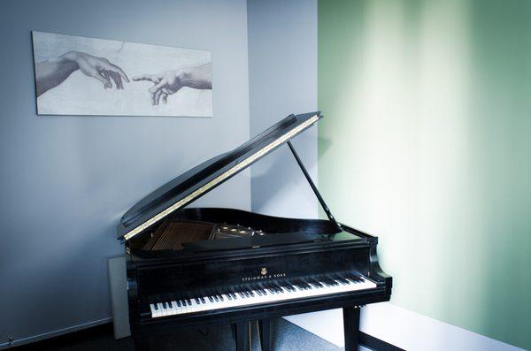 Acoustic grand pianos in every teaching room.