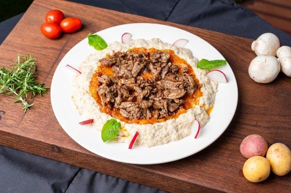 Hummus topped with beef