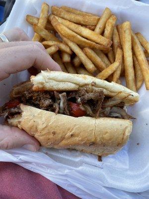 Really good Steak and cheese with peppers and onions and ketchup and fries on the side