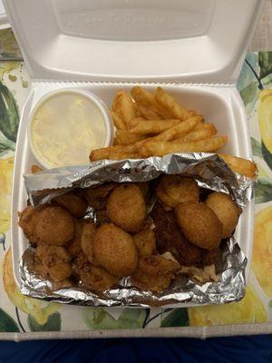 Custom platter with fried shrimp, deviled crab and underneath the foil is the BBQ. Sides are hush puppy, fries, and potato salad