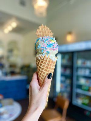 Lemon on the bottom, + strawberry matcha on top, in a waffle cone, with sprinkles