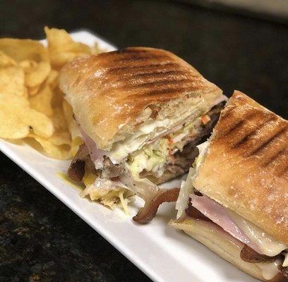 Our Cuban is made with delicious Marinated Roasted Pork, Ham, Swiss Cheese, Pickles & Creamy Coleslaw