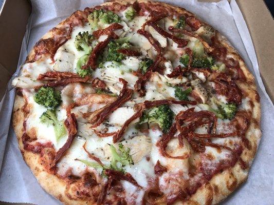 Custom 10 inch cheese pizza with chicken, broccoli, and sun dried tomato