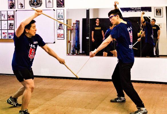 Learn Double Sticks Weapons Training for self-defense in our Kali Escrima group classes @ Tandez Academy.