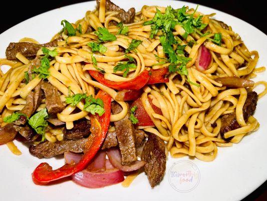 Tallarin Saltado de Carne. It's sautéed with beef, onions, tomatoes and noodles.