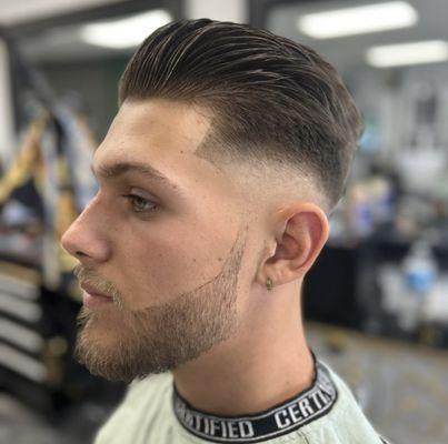 Mid razor skin fade all shear work on top with side edging and beard trim with line up .