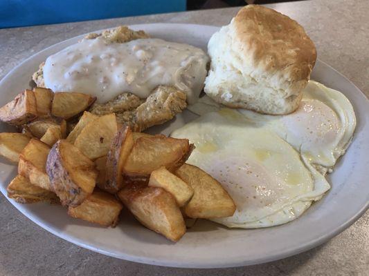 Country Fried Steak with home fries, 2 eggs over easy and an AWESOME biscuit.