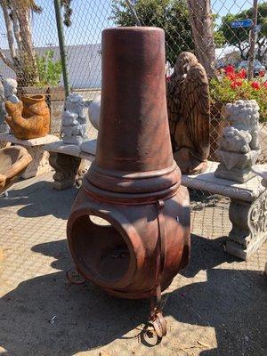 clay chiminea with iron stand