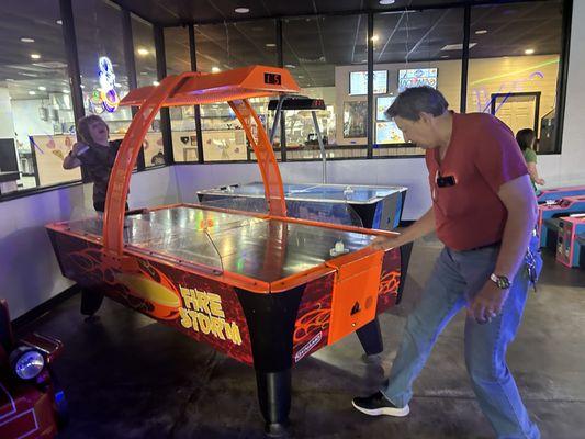 My hubby and son playing air hockey