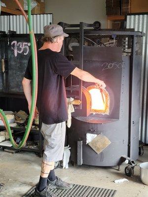 The oven where he gathers the molten glass