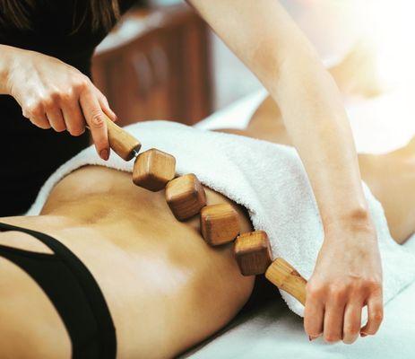 a woman receiving wood therapy to hips and flanks