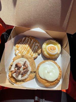 espresso brown butter toffee cookie, banana bread cookie, lemon meringue cookie, and white chocolate caramel macadamia nut cookie