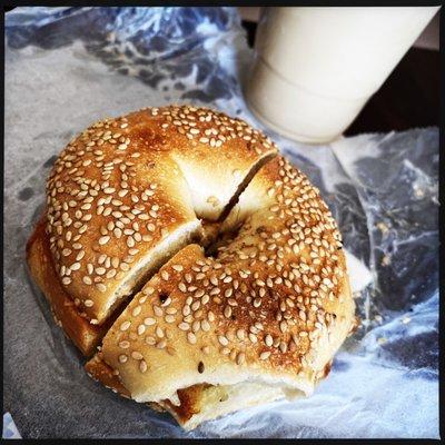 Sesame bagel with butter and an iced coffee