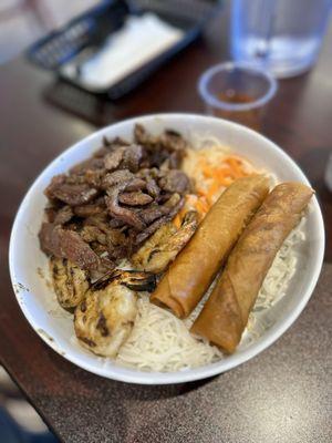 Vermicelli bowl with grilled pork, shrimps, and spring rolls