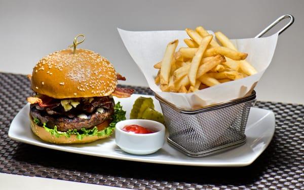 The BOB Burger! Smoked Bacon, caramelized Onions, Blue cheese, lettuce, tomato and a sesame bun, with fries.