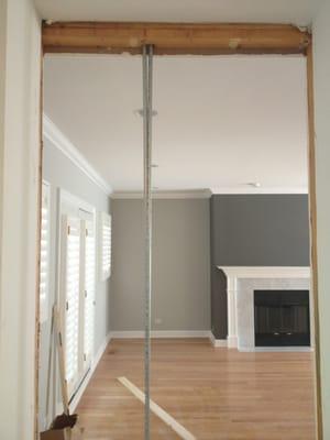 Opening a pantry wall to make a hallway from the kitchen to the master living room area.