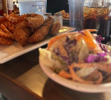 Cole slaw and chicken tenders and fries