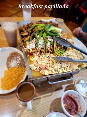 Breakfast parrillada with Mexican egg scramble, chilaquiles, potatoes, rice and beans