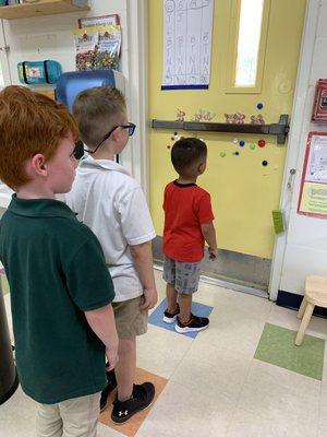 How do we line up to go outside? Orderly! These three boys were showing other children how to do it. They were great examples.