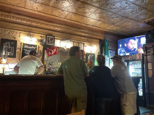 Locals gather on a rainy night for a beer and football