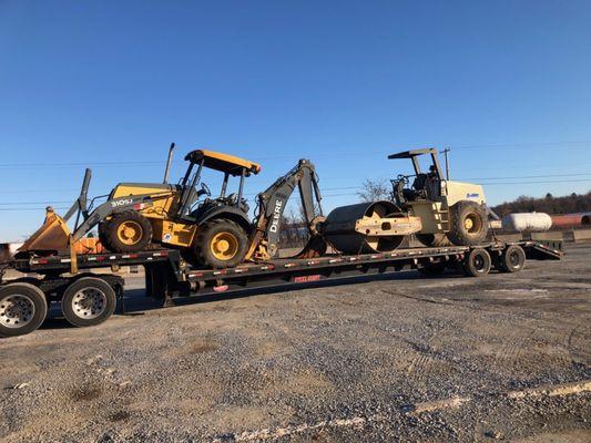 John Deere Dozer and a Roller on a Step deck trailer being loaded right in our backyard in Charleston, SC