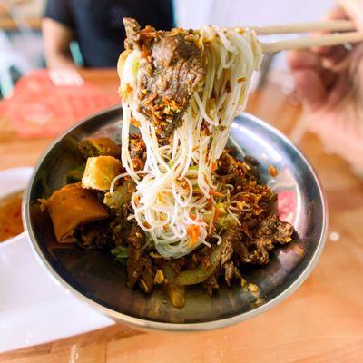 Bun bo xao filet mignon w/ fried crispy eggroll.