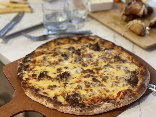 Cheesesteak pizza with hot peppers on the side