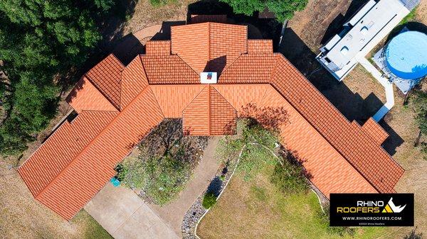 This stone coated metal roof has the beautiful look of terracotta tile with the benefits and durability of a metal roof.