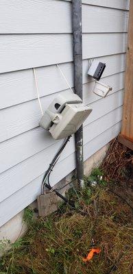 Picture taken after project completion.  Utility boxes left hanging.  Exterior outlet left hanging by copper wires.  Ground wire cut.