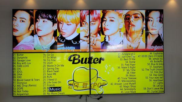 Video screen with K-pop music.