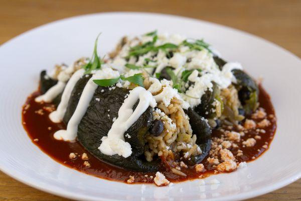 Stuffed Poblano Peppers: Roasted poblano peppers filled with rice, black beans, zucchini, and
yellow squash served over salsa roja.