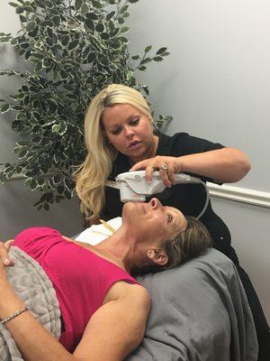 Natalie performing an Ultherapy treatment.