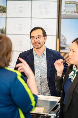 Corporate event photo taken of co-workers talking.