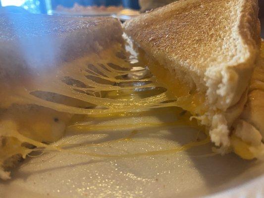 It's cheesy but not as big as other reviewers were saying. There's an extra layer of bread. Stuffed Grilled Cheese